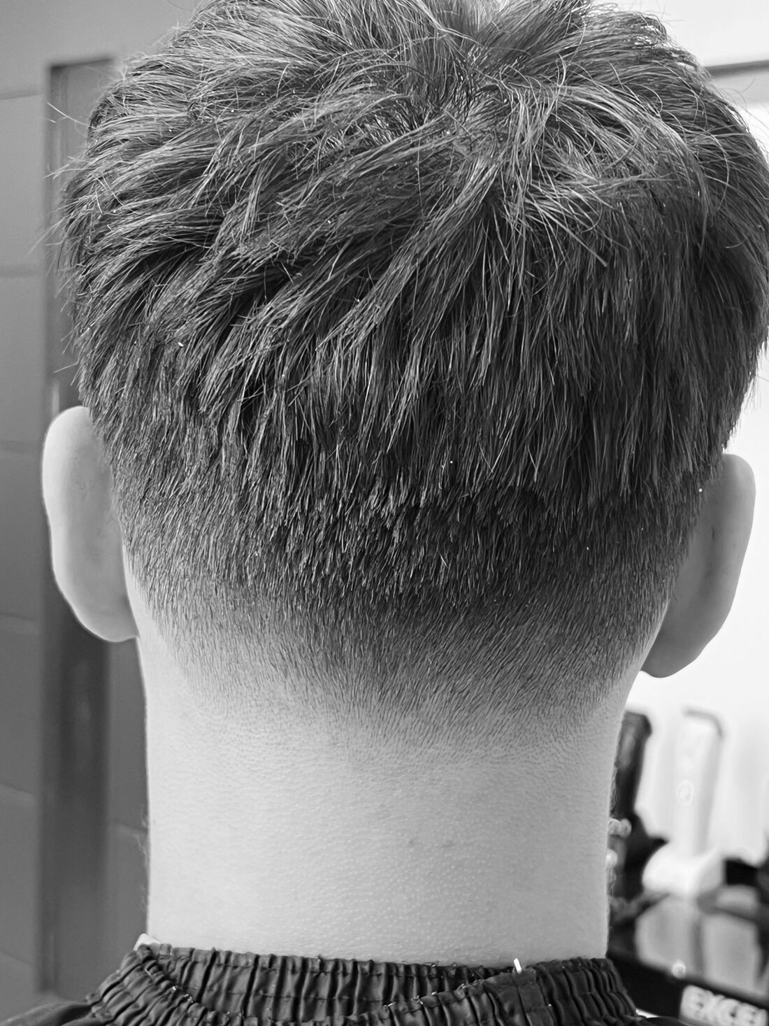 Textured top with a clean skin fade at the neckline, black and white